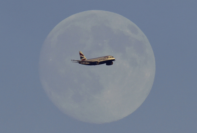a british airways passenger aircraft passes in front of the moon as it makes it 039 s landing approach towards heathrow airport in west london photo reuters
