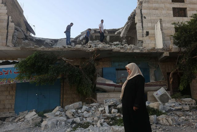 a woman stands on july 18 2016 in front of the house belonging to a palestinian man accused by israeli authorities in taking part in an attack in jerusalem in which an israeli policewoman was killed after it was demolished overnight by the army in the village of qabatiayh in the occupied west bank photo afp a woman stands on july 18 2016 in front of the house belonging to a palestinian man accused by israeli authorities in taking part in an attack in jerusalem in which an israeli policewoman was killed after it was demolished overnight by the army in the village of qabatiayh in the occupied west bank photo afp