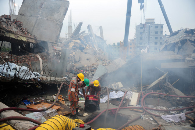 in this photograph taken on april 29 2013 bangladeshi firefighters try to control a blaze during a rescue attempt as bangladeshi army personel begin the second phase of the rescue operation following the rana plaza building collapsed in savar on the outskirts of dhaka photo reuters in this photograph taken on april 29 2013 bangladeshi firefighters try to control a blaze during a rescue attempt as bangladeshi army personel begin the second phase of the rescue operation following the rana plaza building collapsed in savar on the outskirts of dhaka photo reuters