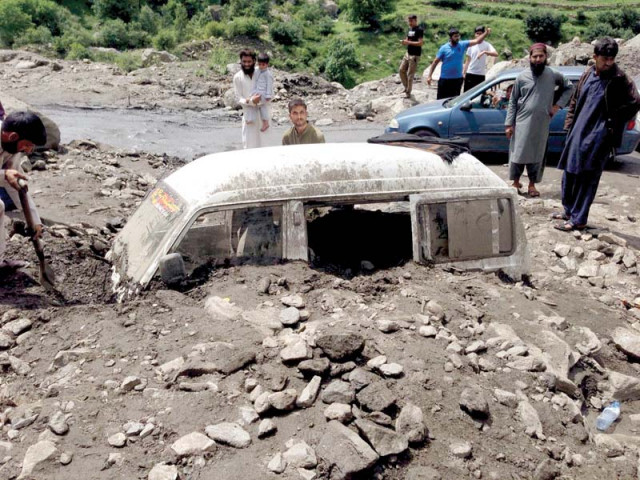 a vehicle damaged due to landslide on kaghan road photo express a vehicle damaged due to landslide on kaghan road photo express