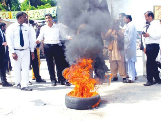 lawyers in gujranwala protest the decision by burning a tyre photo wires lawyers in gujranwala protest the decision by burning a tyre photo wires