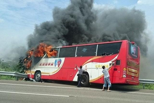 a tour bus in flames after it struck a railing on a highway in taipei photo courtesy xinhua news a tour bus in flames after it struck a railing on a highway in taipei photo courtesy xinhua news