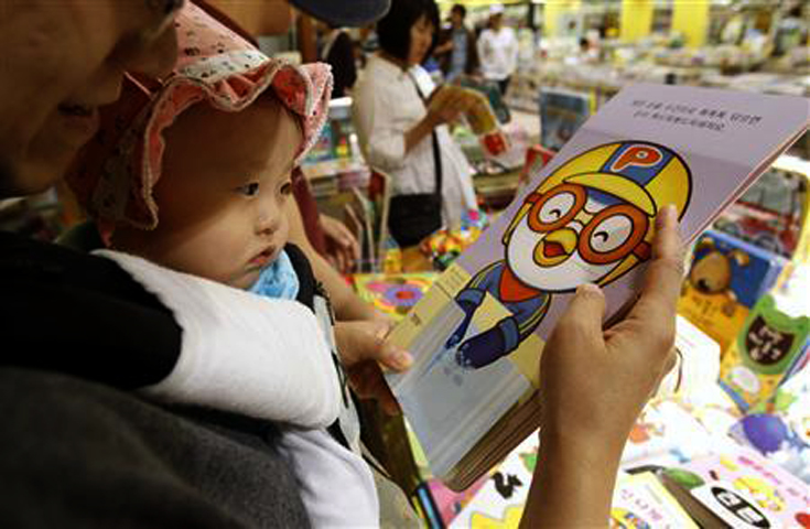 a baby looks at the cartoon character pororo at a book store in seoul may 16 2011 photo reuters