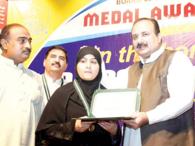 education minister rana mashhood gives a medal to a student at the ceremony photo abid nawaz express education minister rana mashhood gives a medal to a student at the ceremony photo abid nawaz express