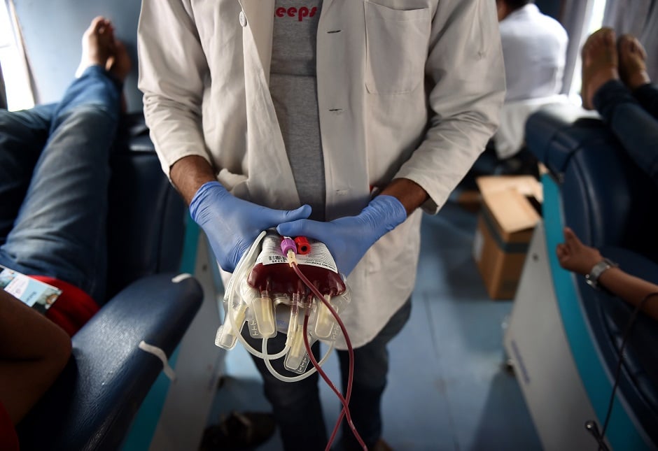 a worker separates bags of donated blood at a camp organised by the rotary blood bank in new delhi photo afp