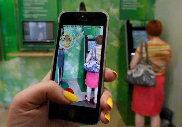 a woman plays the augmented reality mobile game 039 039 pokemon go 039 039 by nintendo photo reuters a woman plays the augmented reality mobile game 039 039 pokemon go 039 039 by nintendo photo reuters
