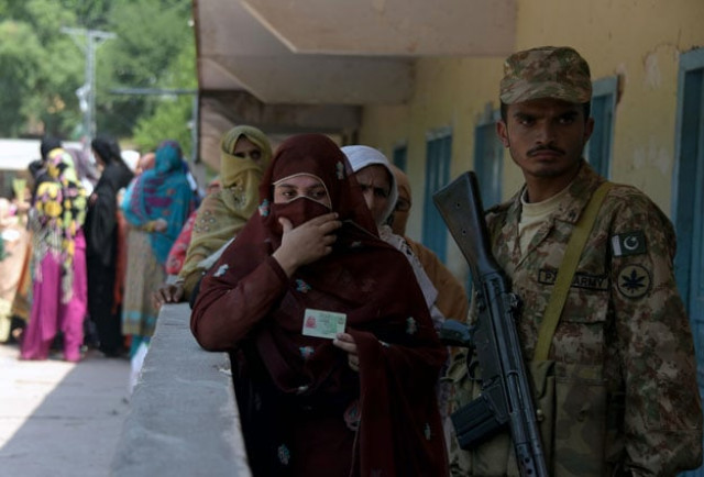 a pakistani army soldier stands guard as kashmiri women line up at a polling station before casting their vote in the general elections in muzaffarabad on july 21 2016 photo afp a pakistani army soldier stands guard as kashmiri women line up at a polling station before casting their vote in the general elections in muzaffarabad on july 21 2016 photo afp