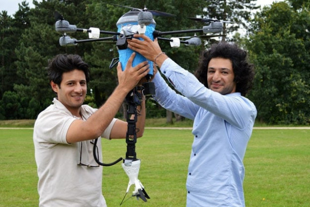 a picture taken on july 4 2016 shows afghan refugee brothers mahmud hassani l and massoud hassani holding their latest anti landmine invention called a quot mine kafon drone quot in eindhoven former refugees massoud and mahmud hassani stunned the world three years ago with an invention like a dandelion puffball that sought to rid the world of landmines now the afghan brothers are back with their latest creation a low cost drone to detect and destroy mines which each year claim thousands of lives photo afp a picture taken on july 4 2016 shows afghan refugee brothers mahmud hassani l and massoud hassani holding their latest anti landmine invention called a quot mine kafon drone quot in eindhoven former refugees massoud and mahmud hassani stunned the world three years ago with an invention like a dandelion puffball that sought to rid the world of landmines now the afghan brothers are back with their latest creation a low cost drone to detect and destroy mines which each year claim thousands of lives photo afp