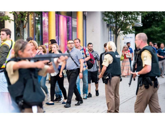 police evacuate people from a shopping mall after multiple shootings in munich on friday photo afp