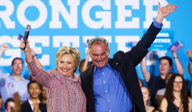 us democratic presidential candidate hillary clinton and us senator tim kaine democrat of virginia waving during a campaign rally at ernst community cultural center in annandale virginia clinton picks senator tim kaine for vice president photo afp