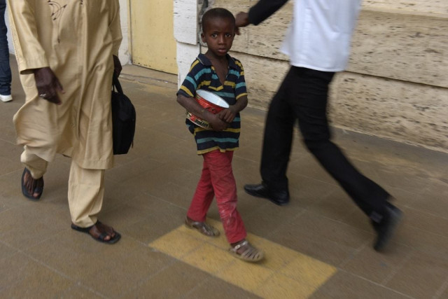 a young senegalese boy locally called talibe begs for ailments in a street in dakar photo afp a young senegalese boy locally called talibe begs for ailments in a street in dakar photo afp