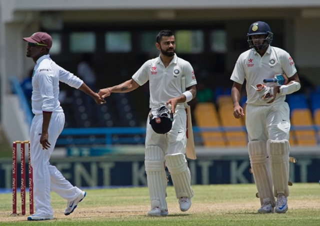 india cricketer virat kohli is congratulated by west indies players after batting 200 runs during day two of the cricket test match between west indies and india july 22 2016 at sir vivian richards stadium in st john 039 s antigua photo afp india cricketer virat kohli is congratulated by west indies players after batting 200 runs during day two of the cricket test match between west indies and india july 22 2016 at sir vivian richards stadium in st john 039 s antigua photo afp