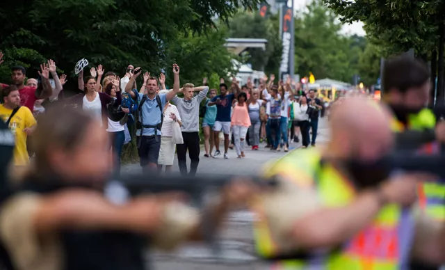 police escorts evacuated people from the shopping mall the olympia einkaufzentrum oez in munich on july 22 2016 following a shootings earlier photo afp police escorts evacuated people from the shopping mall the olympia einkaufzentrum oez in munich on july 22 2016 following a shootings earlier photo afp