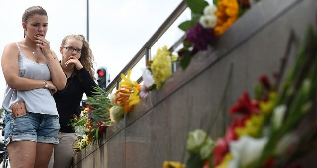 two young women mourn at an underground station near the olympia einkaufszentrum shopping mall in munich on july 23 2016 a day after a mass shooting there photo afp two young women mourn at an underground station near the olympia einkaufszentrum shopping mall in munich on july 23 2016 a day after a mass shooting there photo afp