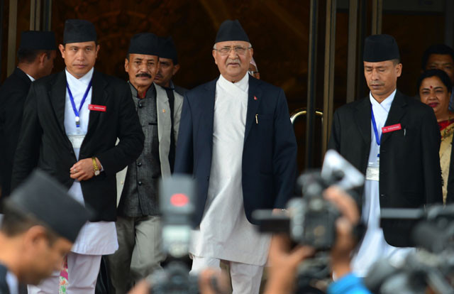 in this photograph taken on july 21 2016 nepalese prime minister kp oli sharma c leaves the parliament building in kathmandu photo afp