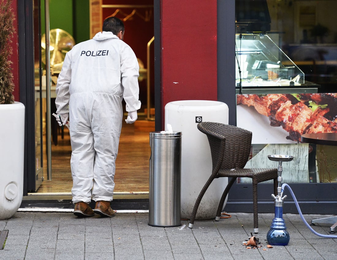 forensic officers investigate the area in front of the fastfood restaurant in reutlingen southwestern germany on july 24 2016 where a syrian asylum seeker killed a woman and injured two people with a machete photo afp