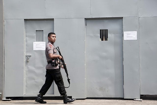 an indonesian policeman guards outside a metal gate at the cilacap port the only gate to indonesia 039 s highest security nusakambangan prison in cilacap on july 25 2016 photo afp