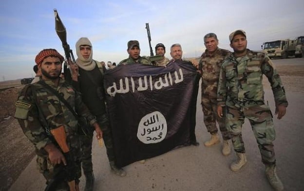 fighters pose with an islamic state flag photo reuters