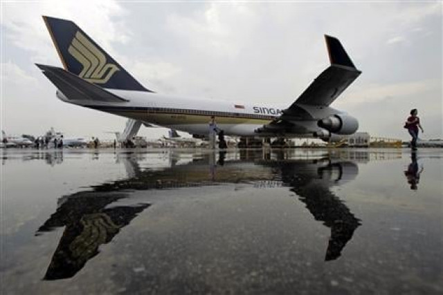 singapore airlines 039 sia boeing 747 400 passenger jet is reflected in a puddle at the singapore airshow in singapore photo reuters singapore airlines 039 sia boeing 747 400 passenger jet is reflected in a puddle at the singapore airshow in singapore photo reuters