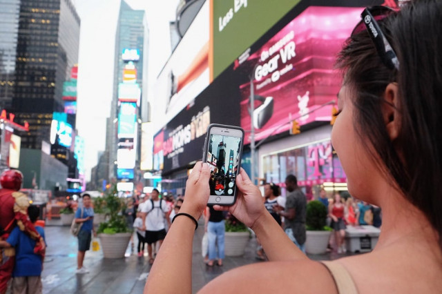 the gaming app landed monday in hong kong and saw residents more glued to their phones than ever photo afp the gaming app landed monday in hong kong and saw residents more glued to their phones than ever photo afp
