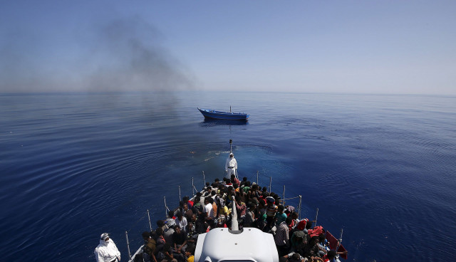 rescued italian police carry migrants to safety leaving their leaky boat to drift photo reuters rescued italian police carry migrants to safety leaving their leaky boat to drift photo reuters