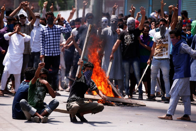 protesters hold sticks as they shout slogans during a protest in srinagar against the recent killings in kashmir photo reuters