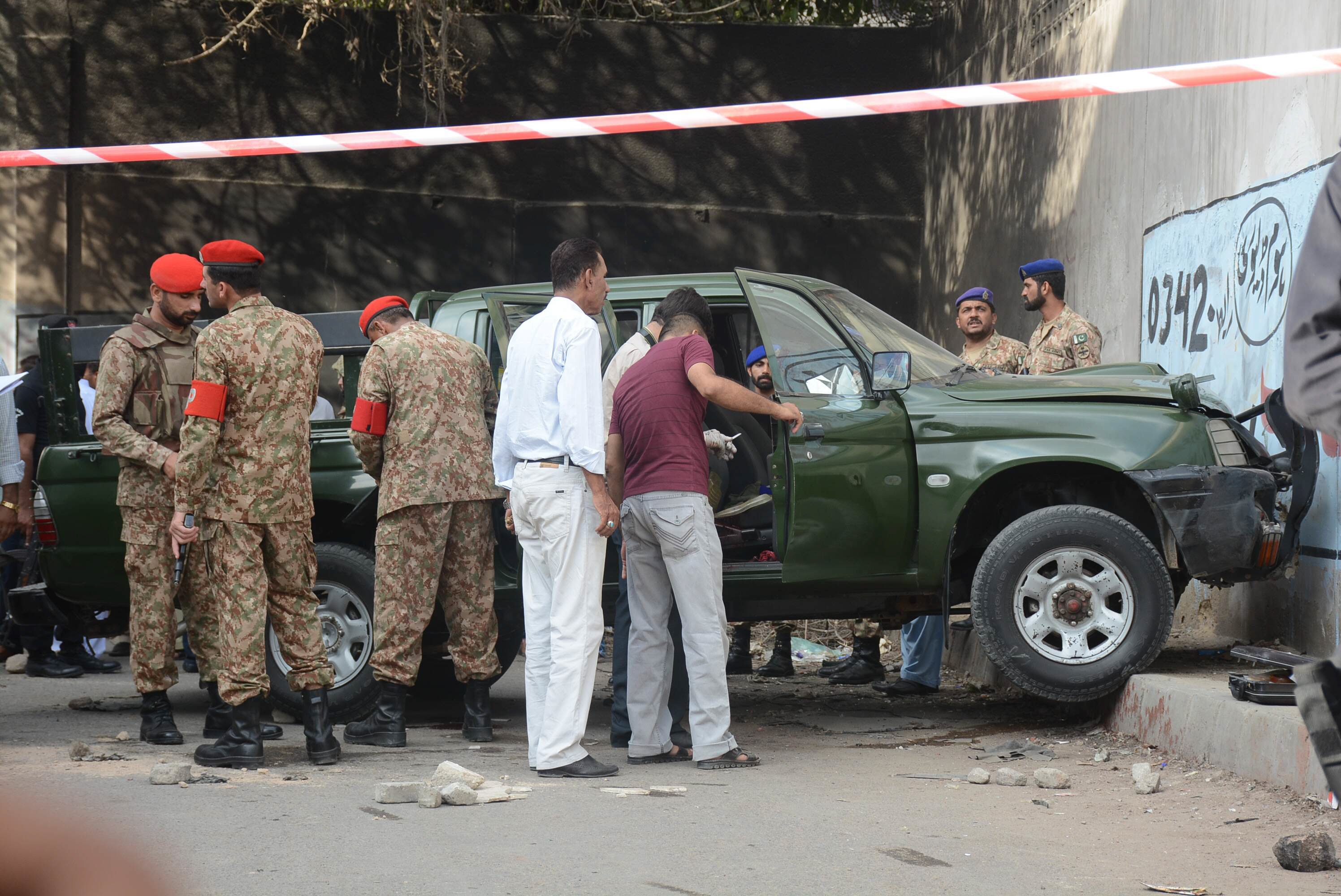 police and soldiers secure the area around an army vehicle after two army personnel were killed by attackers on a motorcycle near parking plaza in karachi 039 s saddar area on tuesday july 26 2016 photo reuters photo mohammad azeem express