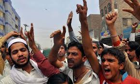 angry mob protesting against blasphemy photo file