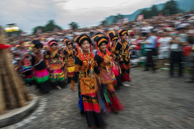 dancers perform at the torch festival in xichang china 039 s sichuan province as a result of fast urbanisation in the rural area of china like lienchang prefecture the traditional costume is fading away for the yi people in dailylife photo afp