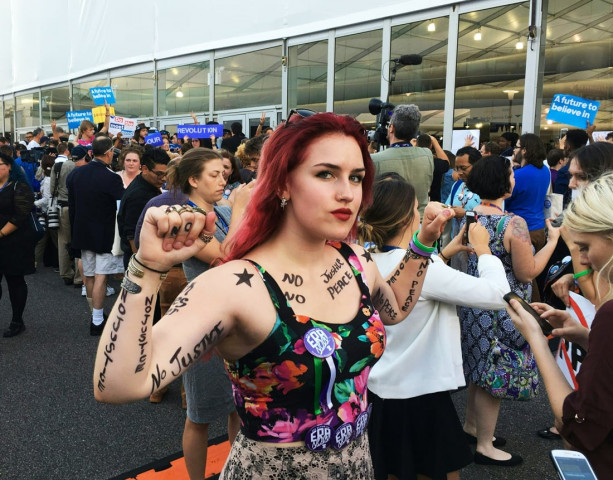 a protester stands in an improvised protest area in front of the media tents on day 2 of the democratic national convention at the wells fargo center in philadelphia pennsylvania july 26 2016 photo afp a protester stands in an improvised protest area in front of the media tents on day 2 of the democratic national convention at the wells fargo center in philadelphia pennsylvania july 26 2016 photo afp
