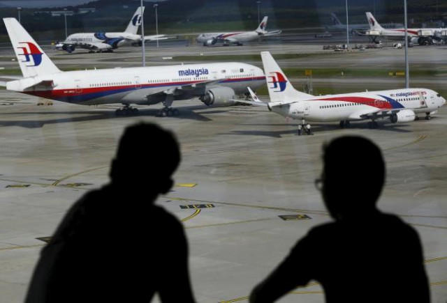 men watch malaysia airlines aircraft at kuala lumpur international airport in sepang malaysia photo reuters men watch malaysia airlines aircraft at kuala lumpur international airport in sepang malaysia photo reuters