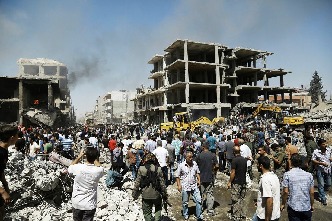 syrians gather at the site of a bomb attack in syria 039 s northeastern city of qamishli on july 27 2016 photo afp