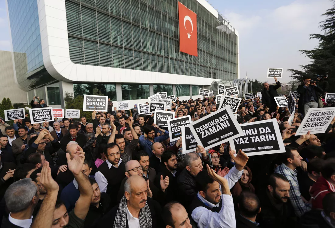 zaman media group employees hold banners outside the headquarters of zaman daily newspaper in istanbul december 14 2014 photo reuters zaman media group employees hold banners outside the headquarters of zaman daily newspaper in istanbul december 14 2014 photo reuters