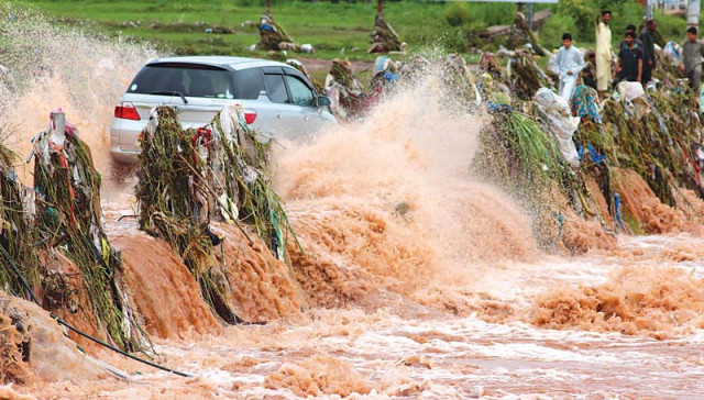 a car crosses over the korang river while it rains in islamabad on wednesday photo muhammad javaid express a car crosses over the korang river while it rains in islamabad on wednesday photo muhammad javaid express