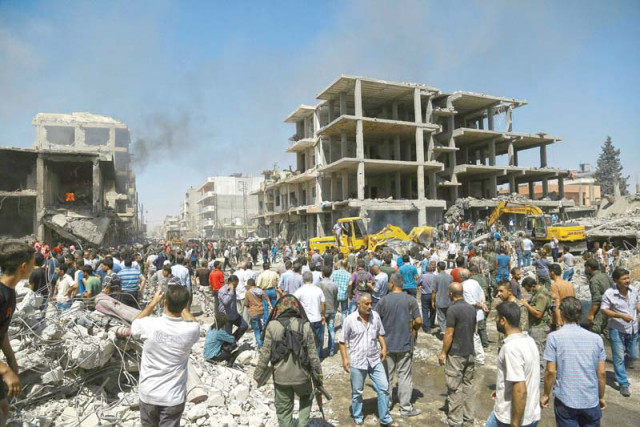 people gather at the site of a bomb attack in qamishli syria photo afp people gather at the site of a bomb attack in qamishli syria photo afp
