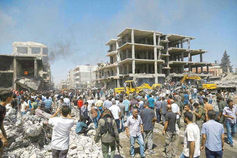 people gather at the site of a bomb attack in qamishli syria photo afp