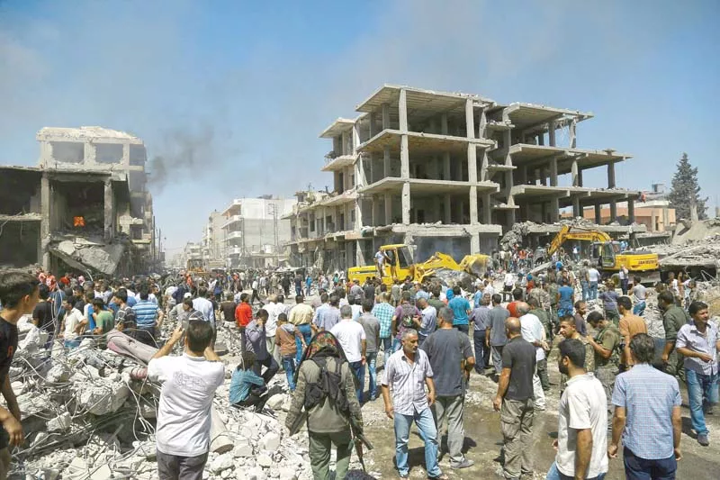 people gather at the site of a bomb attack in qamishli syria photo afp people gather at the site of a bomb attack in qamishli syria photo afp