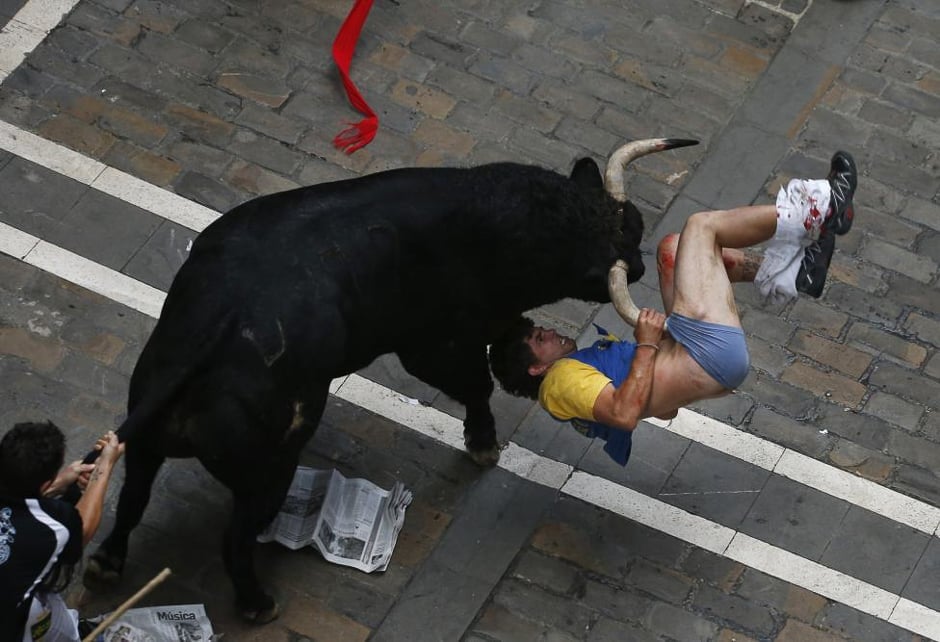 a runner is gored by an el pilar fighting bull on estafeta street during the sixth running of the bulls of the san fermin festival in pamplona spain july 2013 the runner was gored three times reuters susana vera