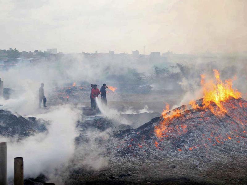 firefighters try to put out the blaze that erupted at a godown located off the super highway near sabzi mandi on thursday photo online