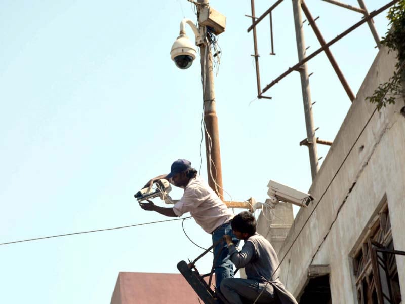 a man fixing a cctv camera in saddar during muharram last year photo file