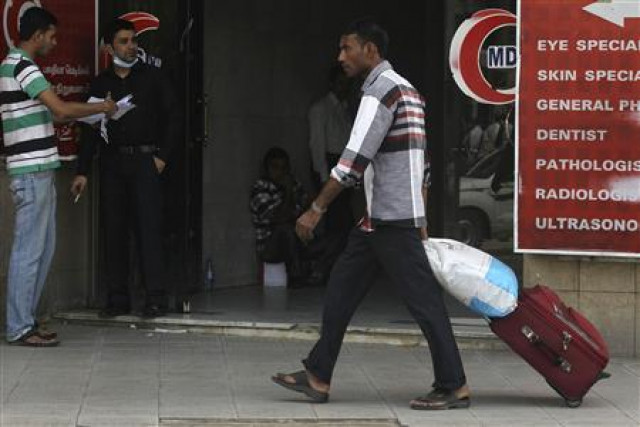 a foreign worker pulls his luggage along a street in riyadh photo reuters a foreign worker pulls his luggage along a street in riyadh photo reuters