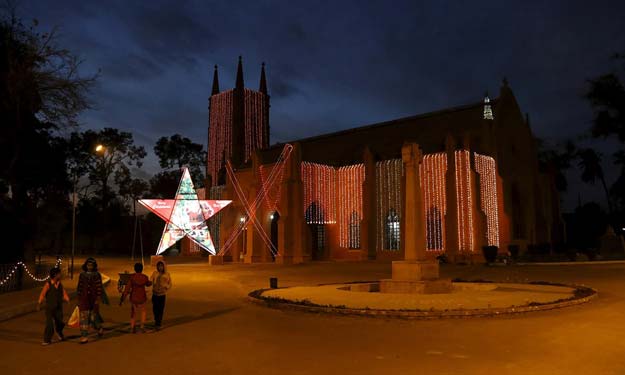 children come out after visiting the st john cathedral church illuminated with lights ahead of christmas celebrations in peshawar photo reuters