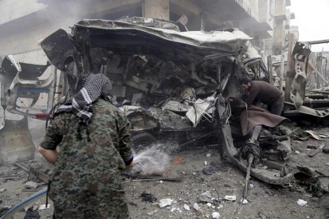 a man sprays water on an ambulance at a site hit by what activists said were three consecutive air strikes photo reuters