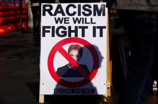 a protester casts his shadow across a poster displaying australia 039 s far right politician pauline hanson photo reuters a protester casts his shadow across a poster displaying australia 039 s far right politician pauline hanson photo reuters