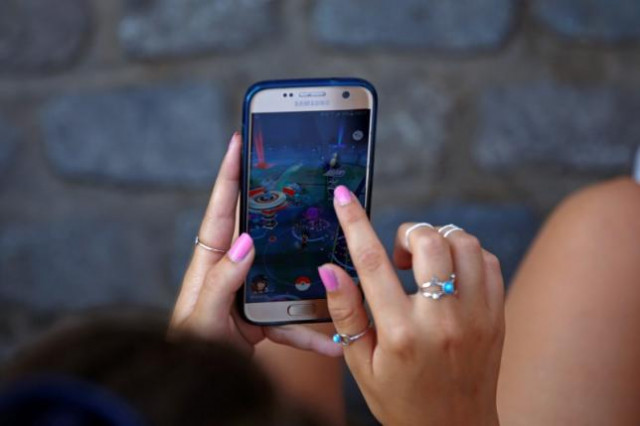 a young woman plays the augmented reality mobile game quot pokemon go quot by nintendo at puerta del sol square in madrid spain july 28 2016 photo reuters a young woman plays the augmented reality mobile game quot pokemon go quot by nintendo at puerta del sol square in madrid spain july 28 2016 photo reuters