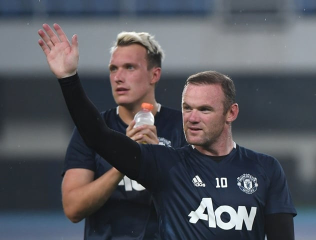 manchester united 039 s wayne rooney waves to fans as teammate phil jones looks on at the end of a training session a day before the 2016 international champions cup football match between manchester city and manchester united in beijing on july 24 2016 photo afp manchester united 039 s wayne rooney waves to fans as teammate phil jones looks on at the end of a training session a day before the 2016 international champions cup football match between manchester city and manchester united in beijing on july 24 2016 photo afp