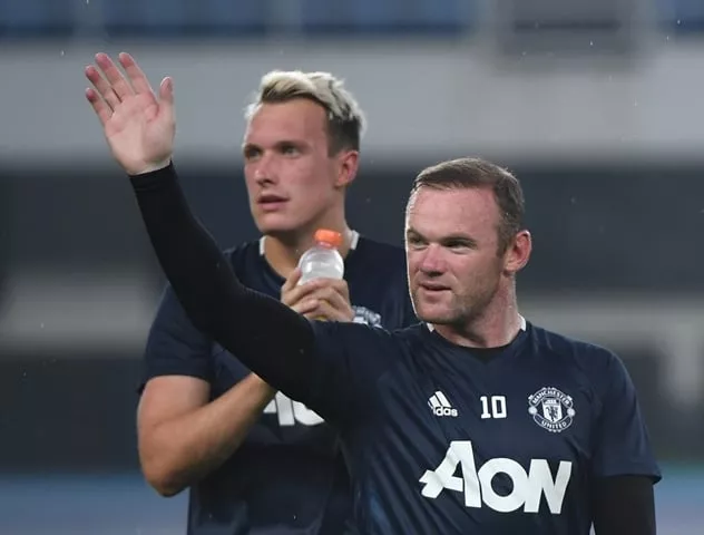 manchester united 039 s wayne rooney waves to fans as teammate phil jones looks on at the end of a training session a day before the 2016 international champions cup football match between manchester city and manchester united in beijing on july 24 2016 photo afp manchester united 039 s wayne rooney waves to fans as teammate phil jones looks on at the end of a training session a day before the 2016 international champions cup football match between manchester city and manchester united in beijing on july 24 2016 photo afp