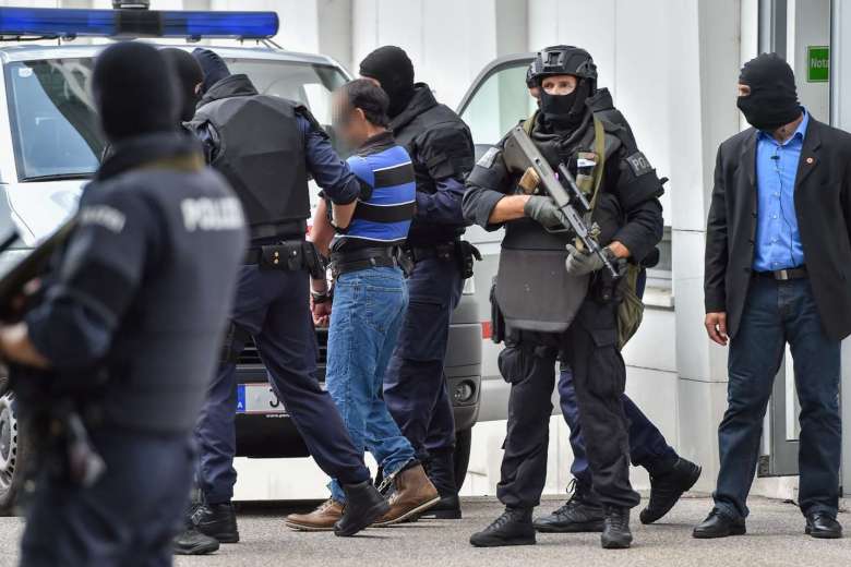 a man suspected of being involved in the november 2015 paris terror attacks is led away by austrian police from the court in linz photo afp