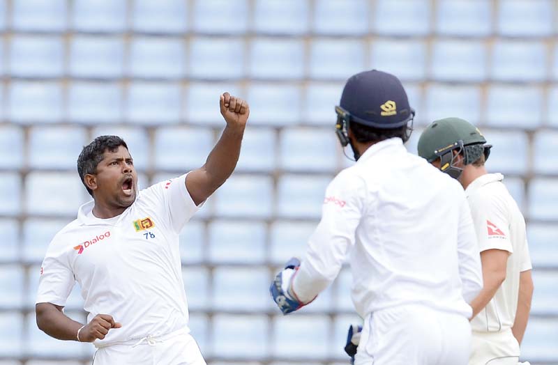 herath celebrates after dismissing warner during the fourth day of the opening test between sri lanka and australia at the pallekele international cricket stadium photo afp