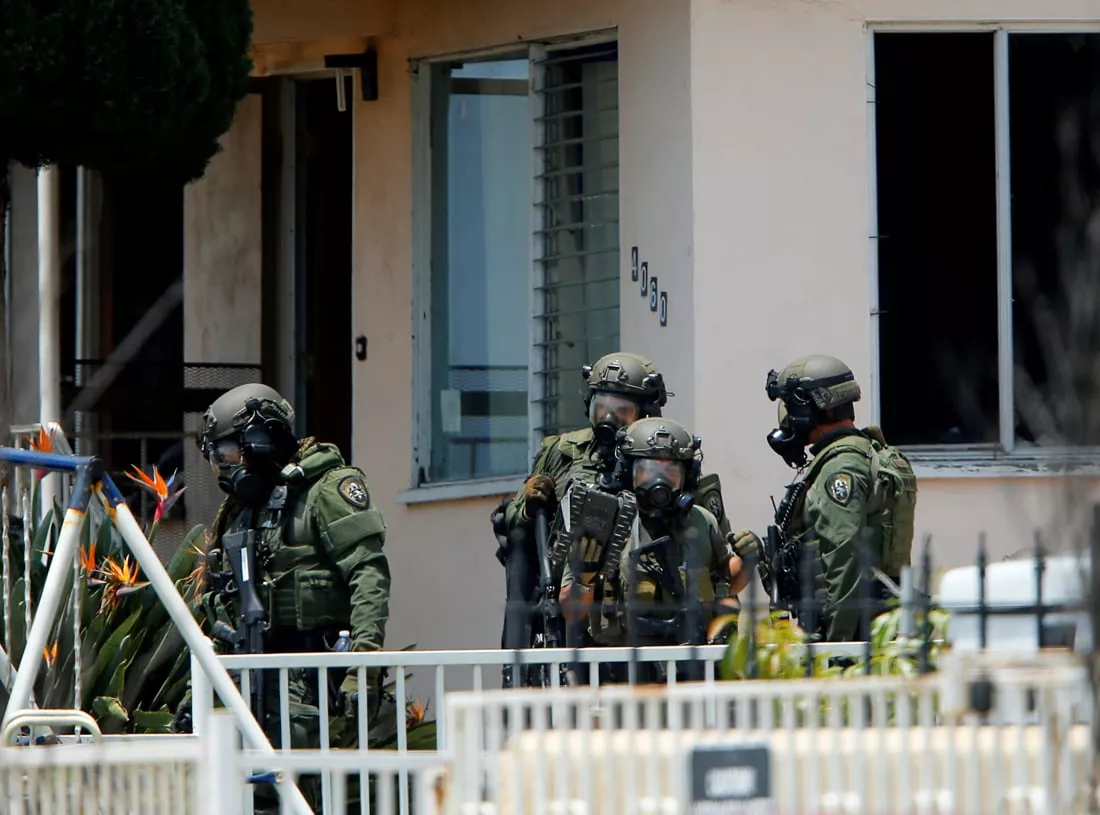 a police swat team leaves a home they had surrounded while searching for a second suspect after a san diego police officer was fatally shot and another was wounded late on thursday in san diego california united states july 29 2016 photo reuters